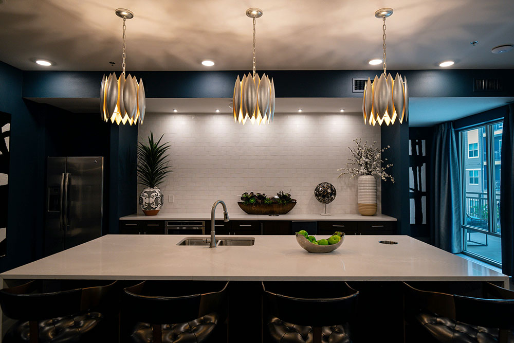 Dark cabinetry framing a bright stone kitchen island