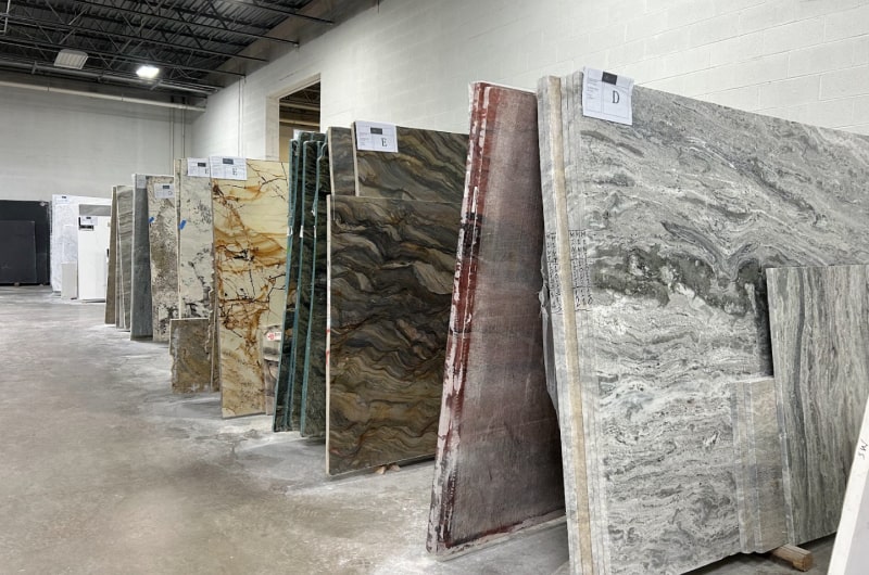 Full-size stone slabs displayed in Royal Marble’s Pine Brook showroom