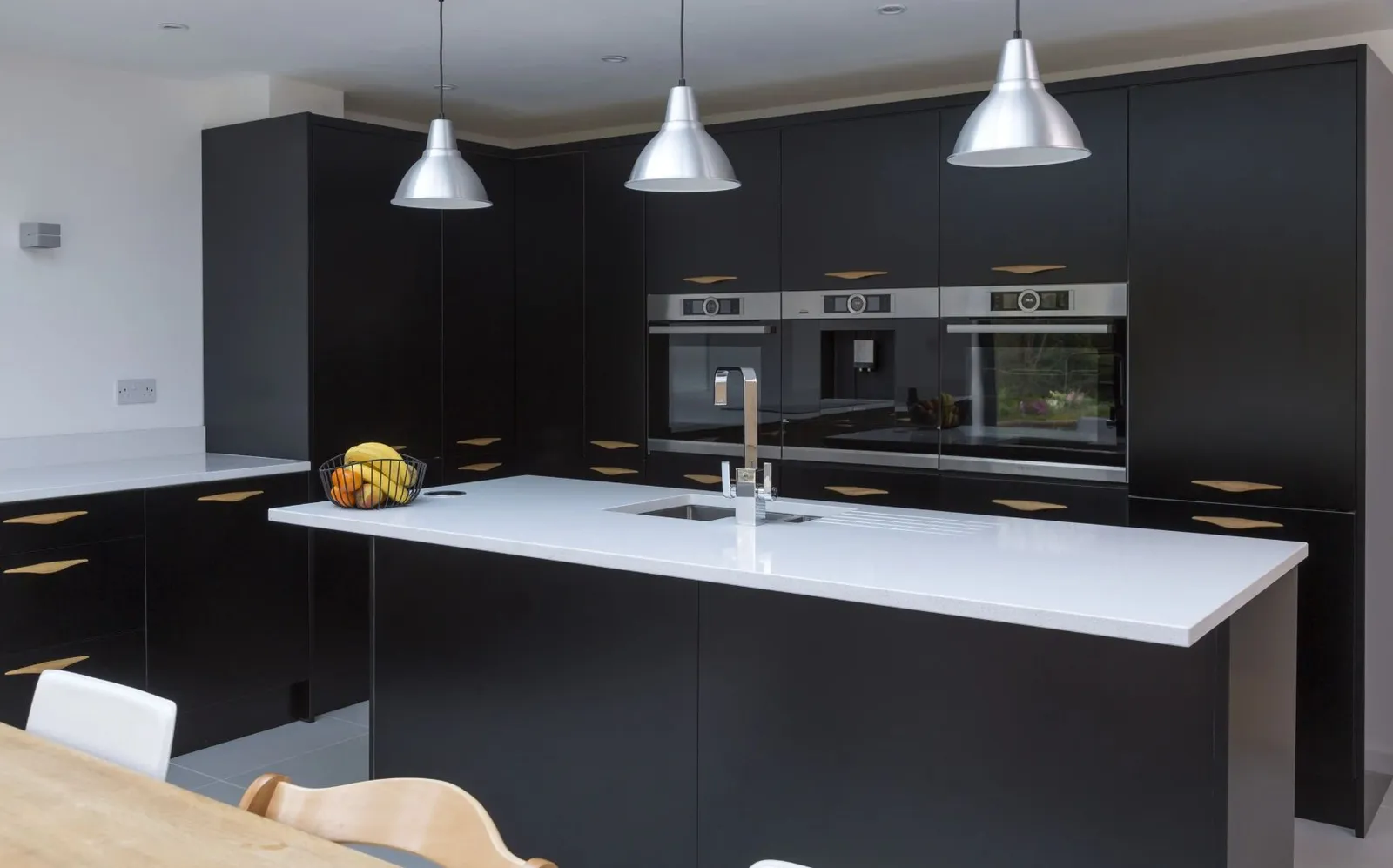 White Quartz Countertops with Black Kitchen Cabinets